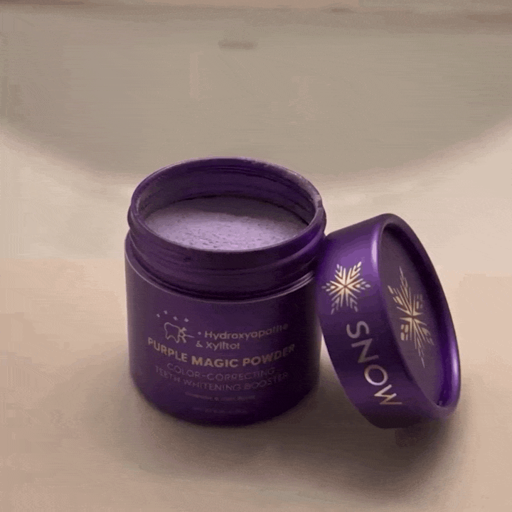 Sprinkling the purple powder onto a toothbrush