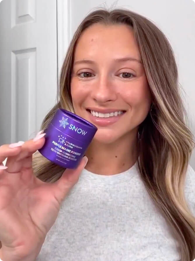 Woman smiling and holding the Purple Magic Powder jar